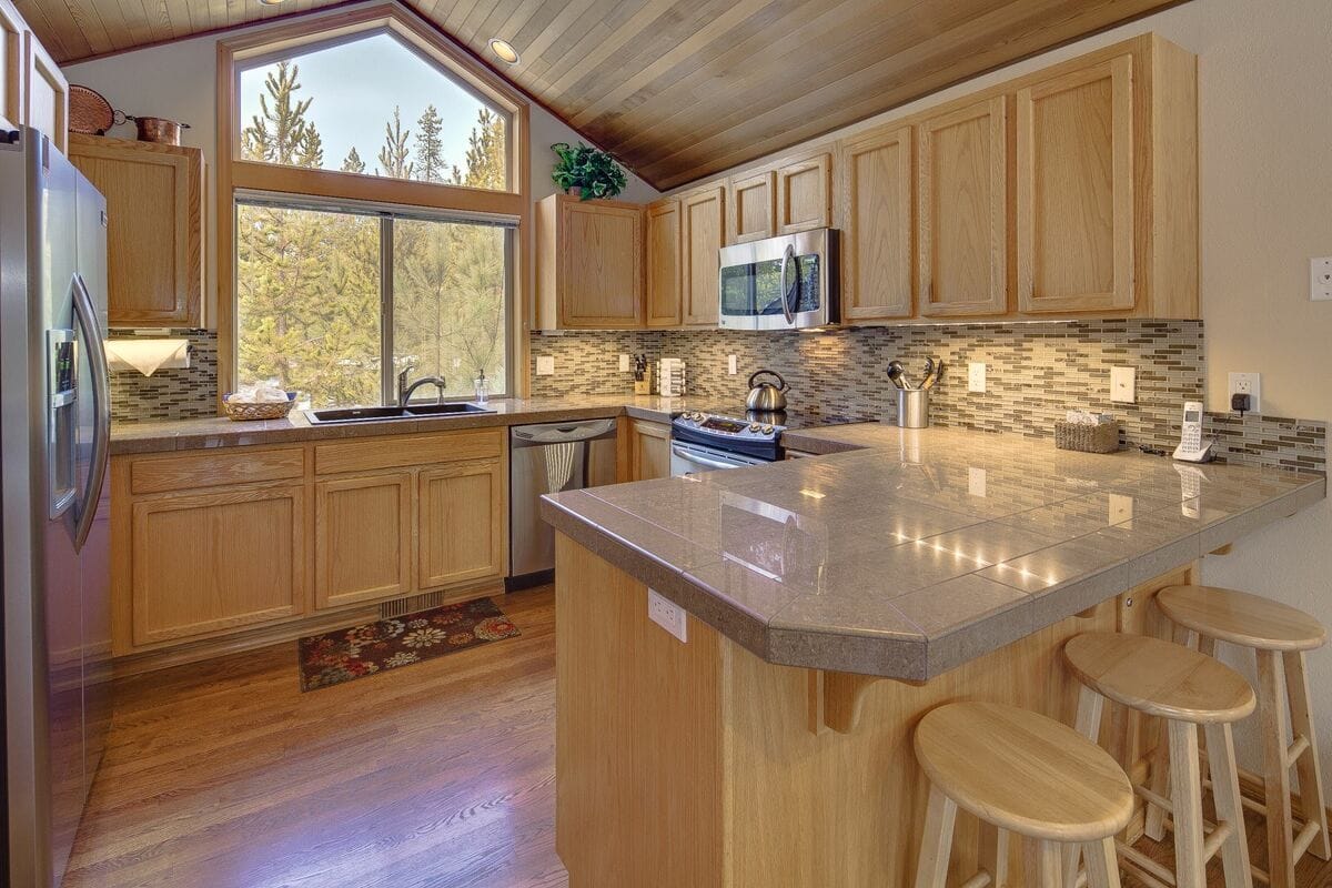 Wooden kitchen with island counter.