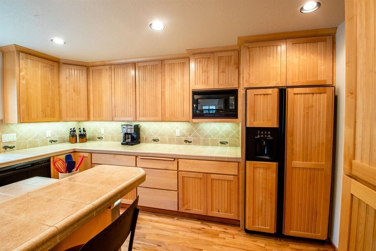 Wooden kitchen with modern appliances.