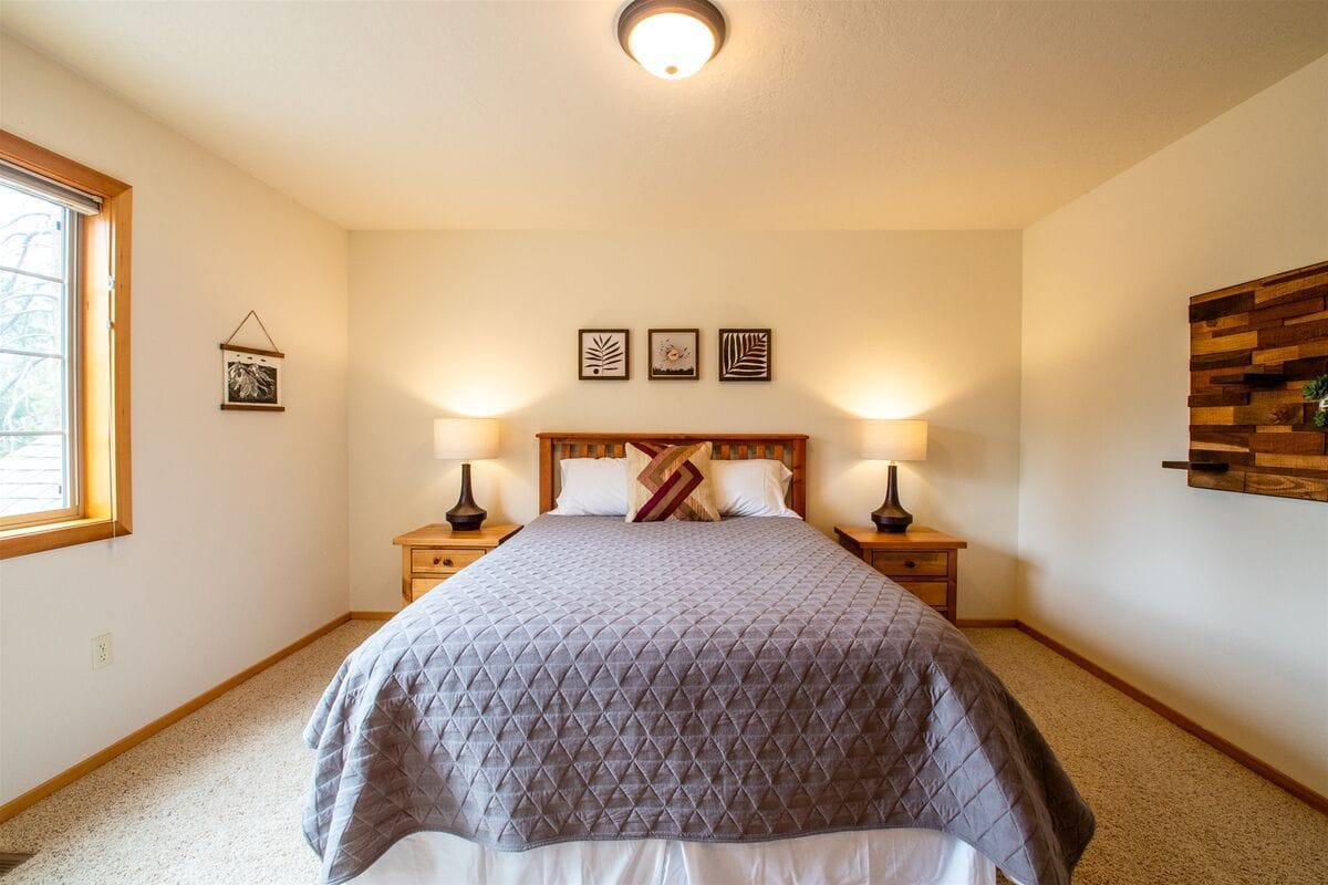 Cozy bedroom with framed artwork.