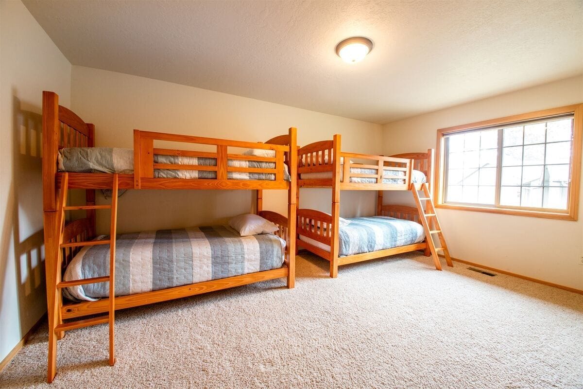 Room with two wooden bunk beds.