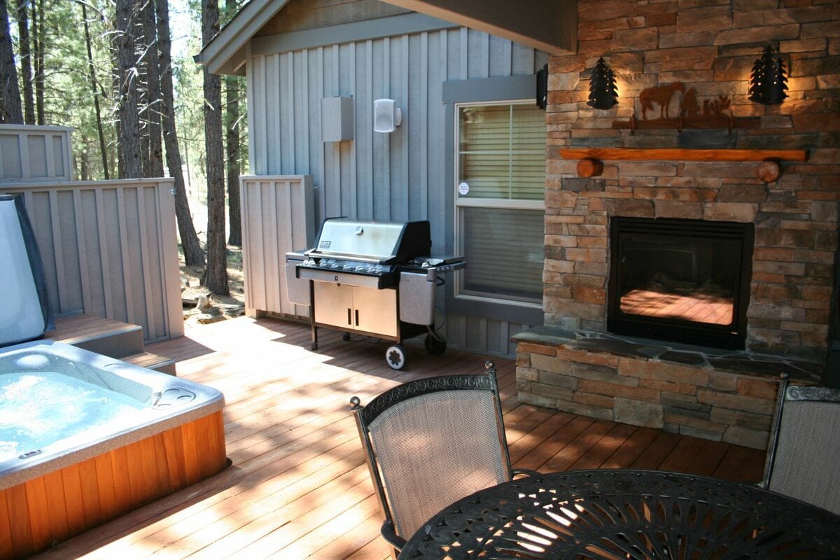 Patio with grill, fireplace, hot tub.