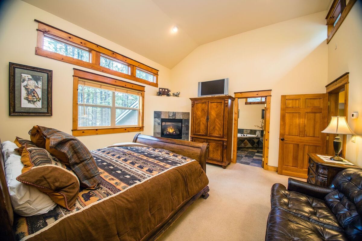 Cozy bedroom with fireplace, sofa.