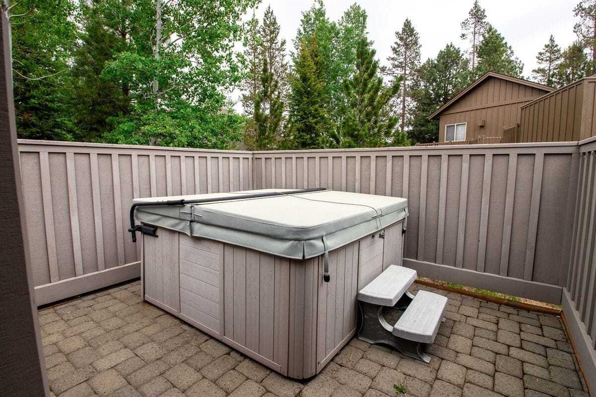 Covered hot tub on patio.