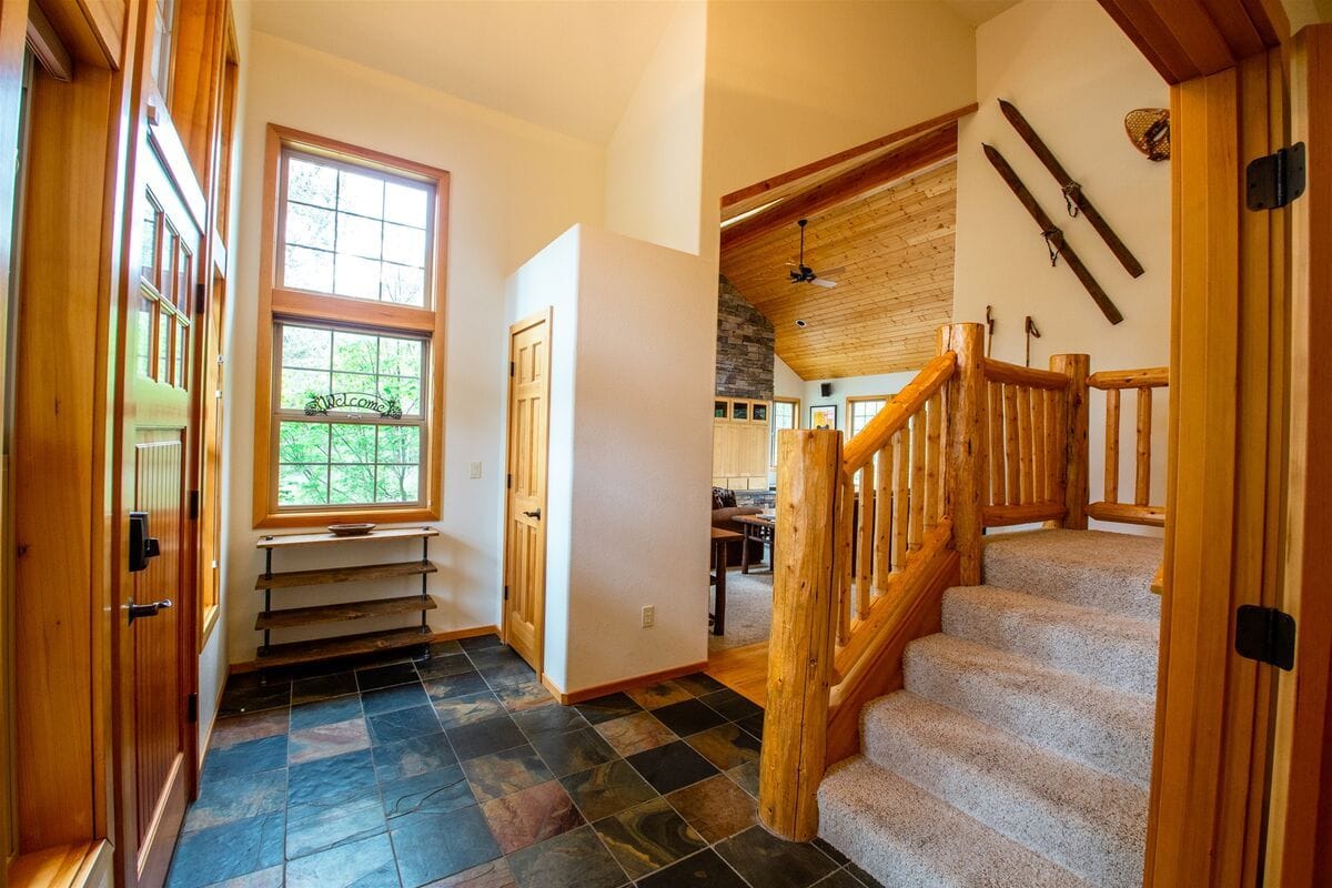 Rustic hallway with wooden stairs.