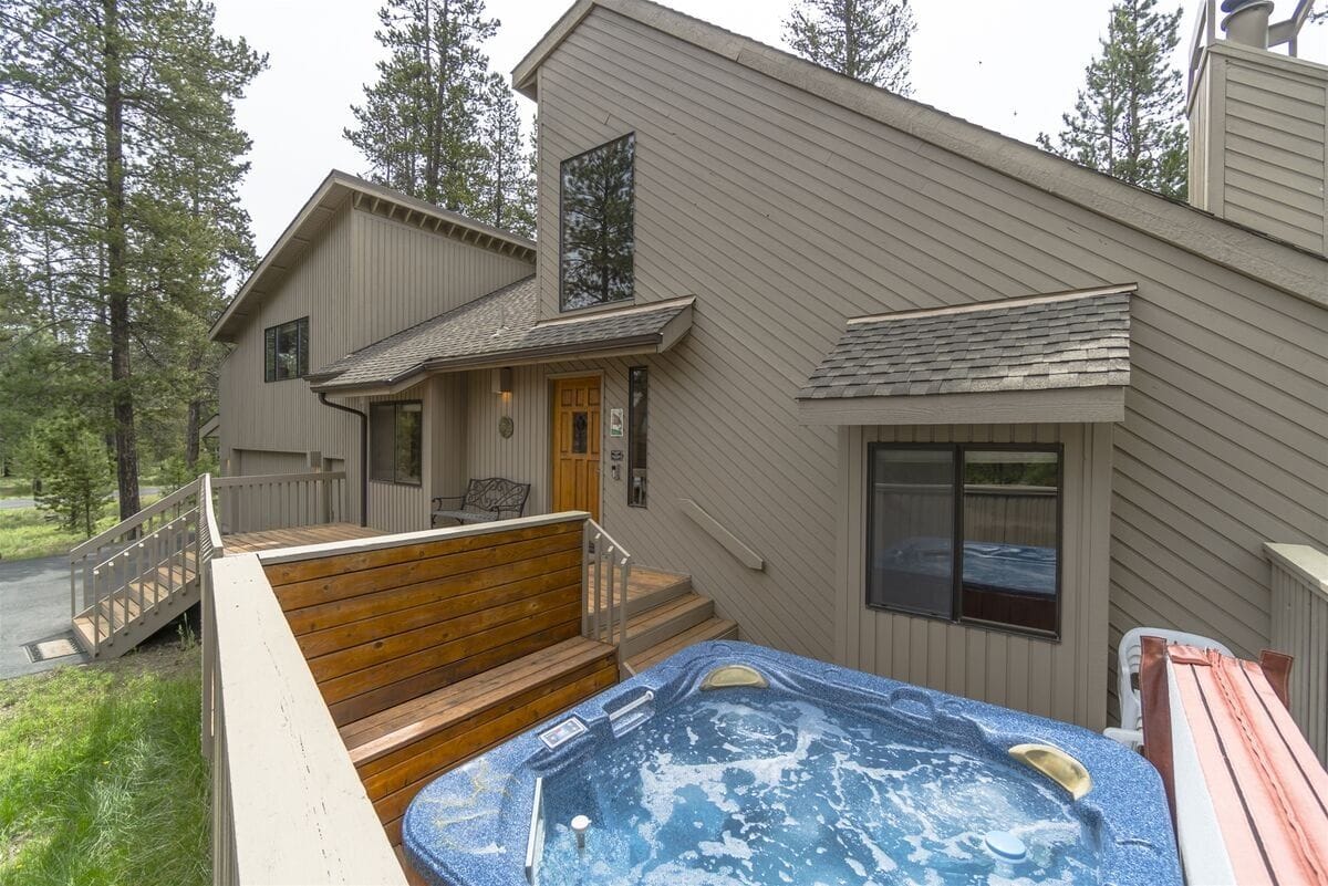 House exterior with outdoor hot tub.