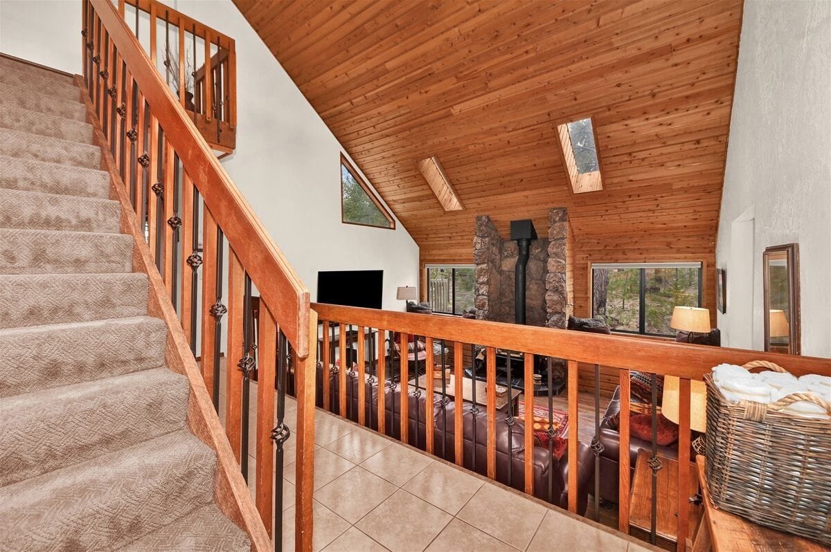 Wooden interior with stone fireplace.