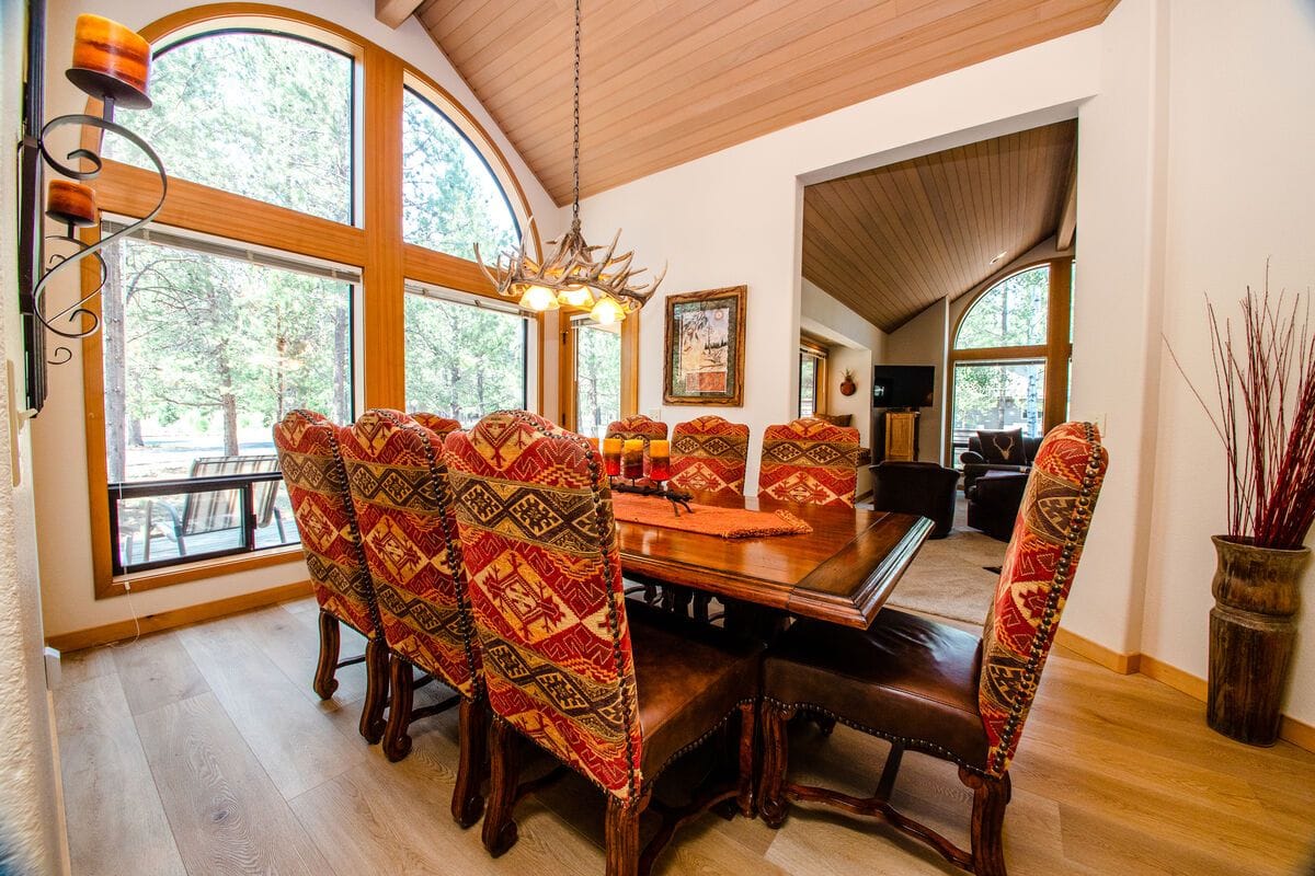 Rustic dining room with large windows.