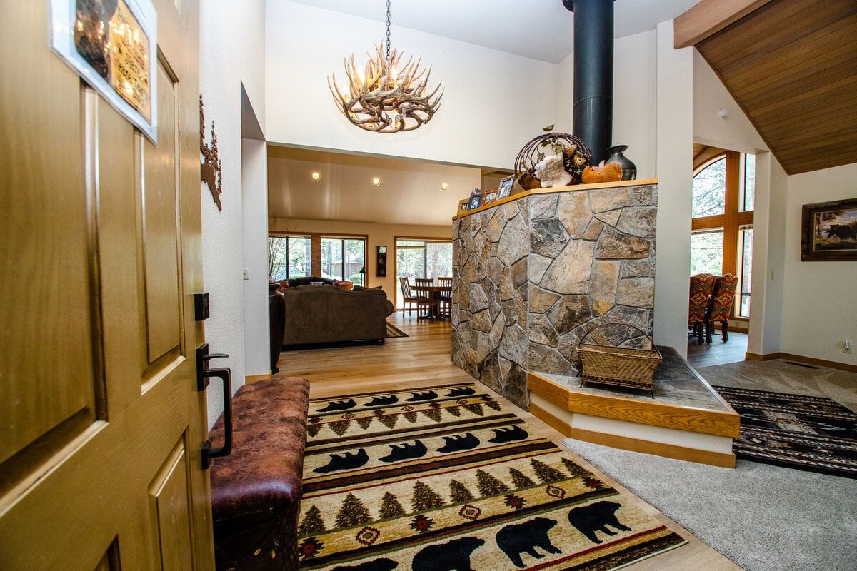 Rustic entryway with antler chandelier.