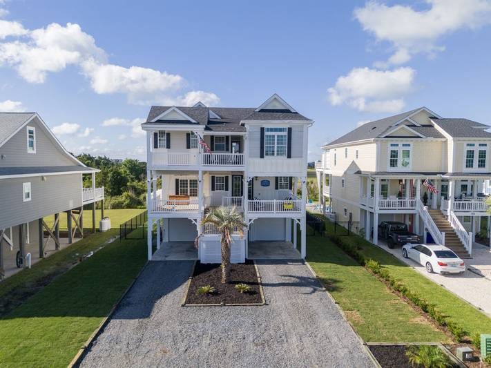 Three elevated houses with palm tree.