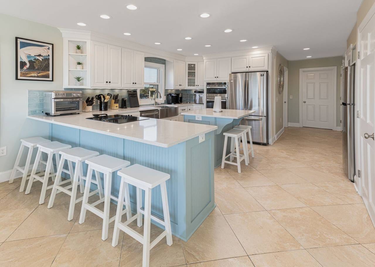 Modern kitchen with blue island.