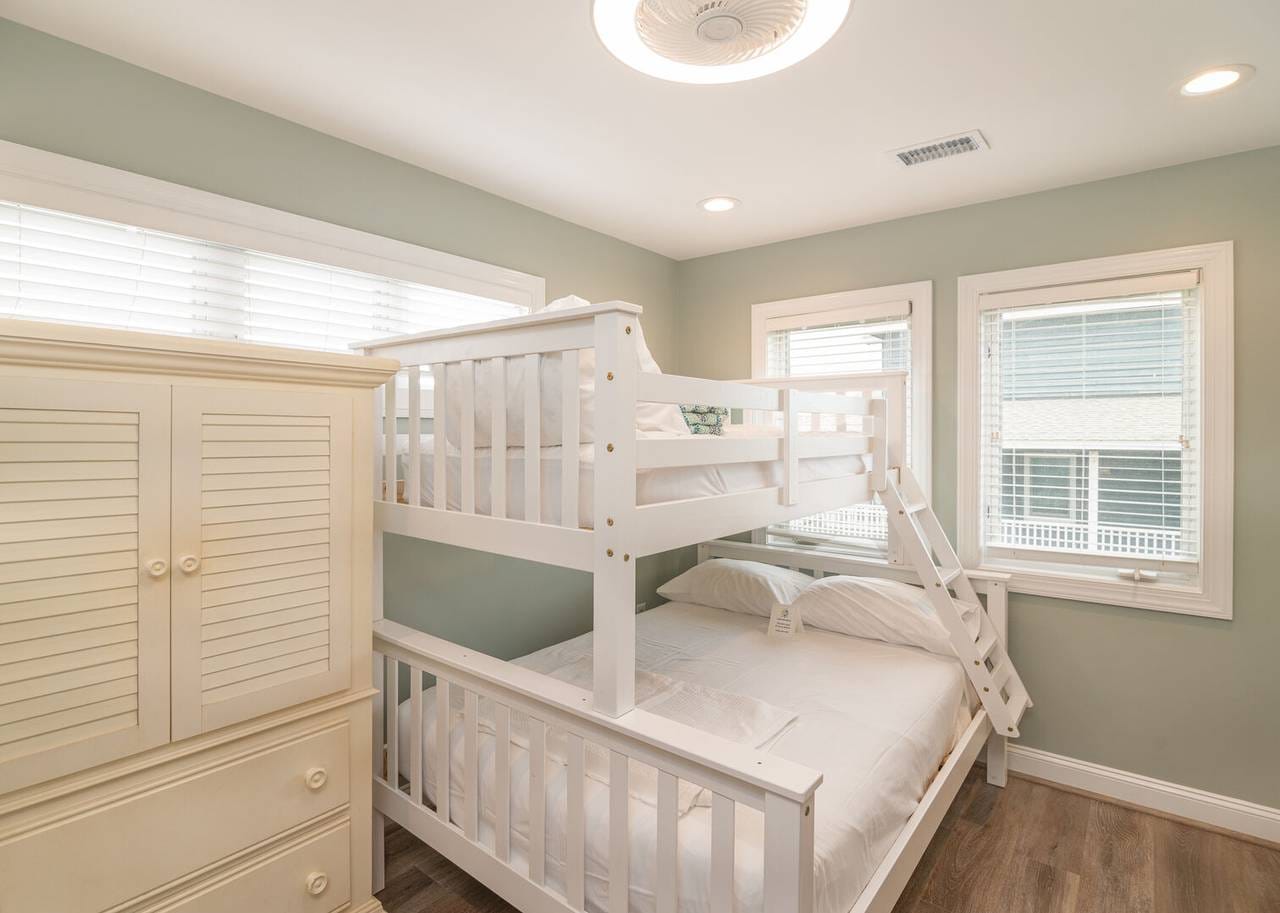 Bedroom with white bunk beds.