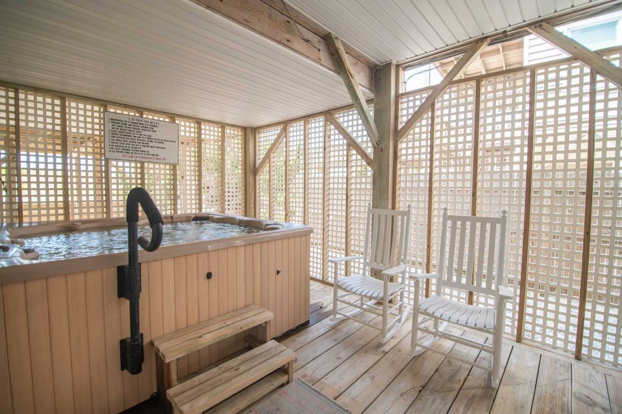 Indoor hot tub with two chairs.