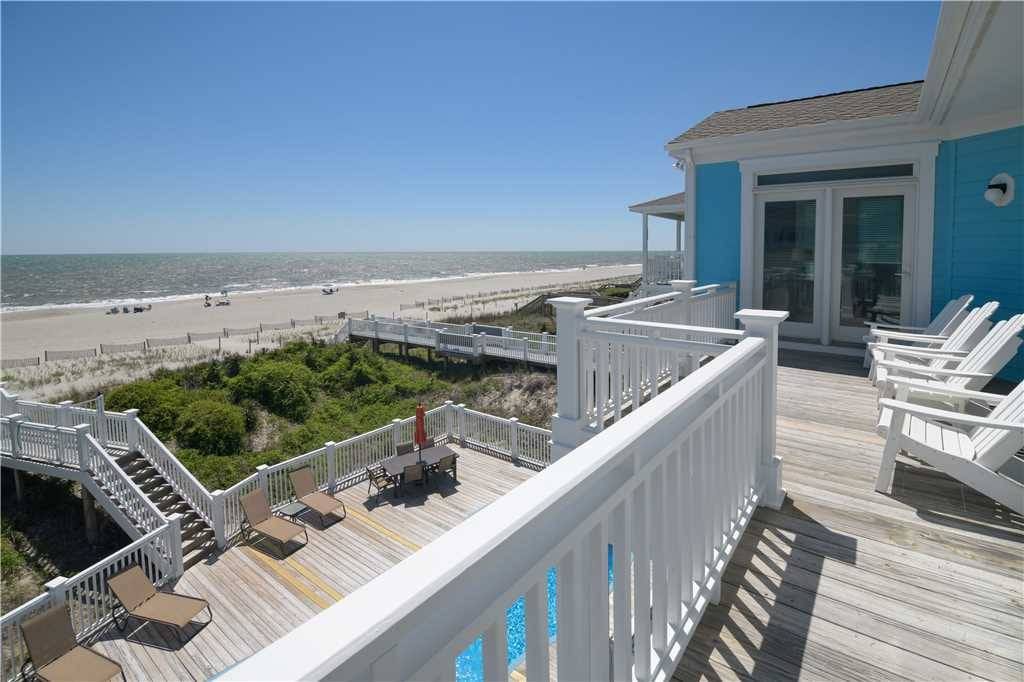 Beachfront house with deck chairs.