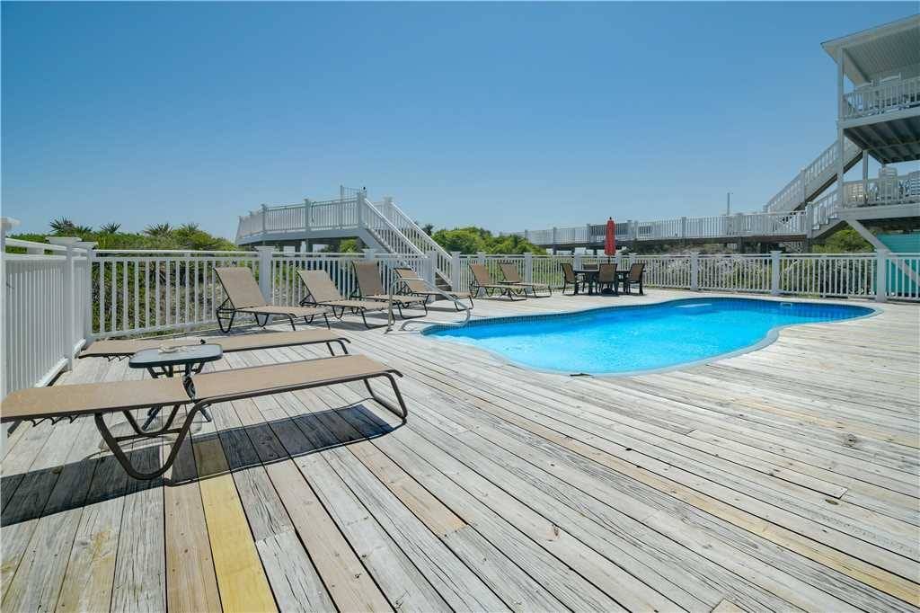 Poolside deck with lounge chairs.