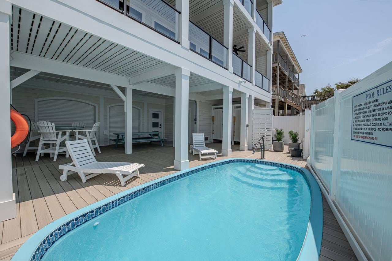 Outdoor pool with deck chairs.