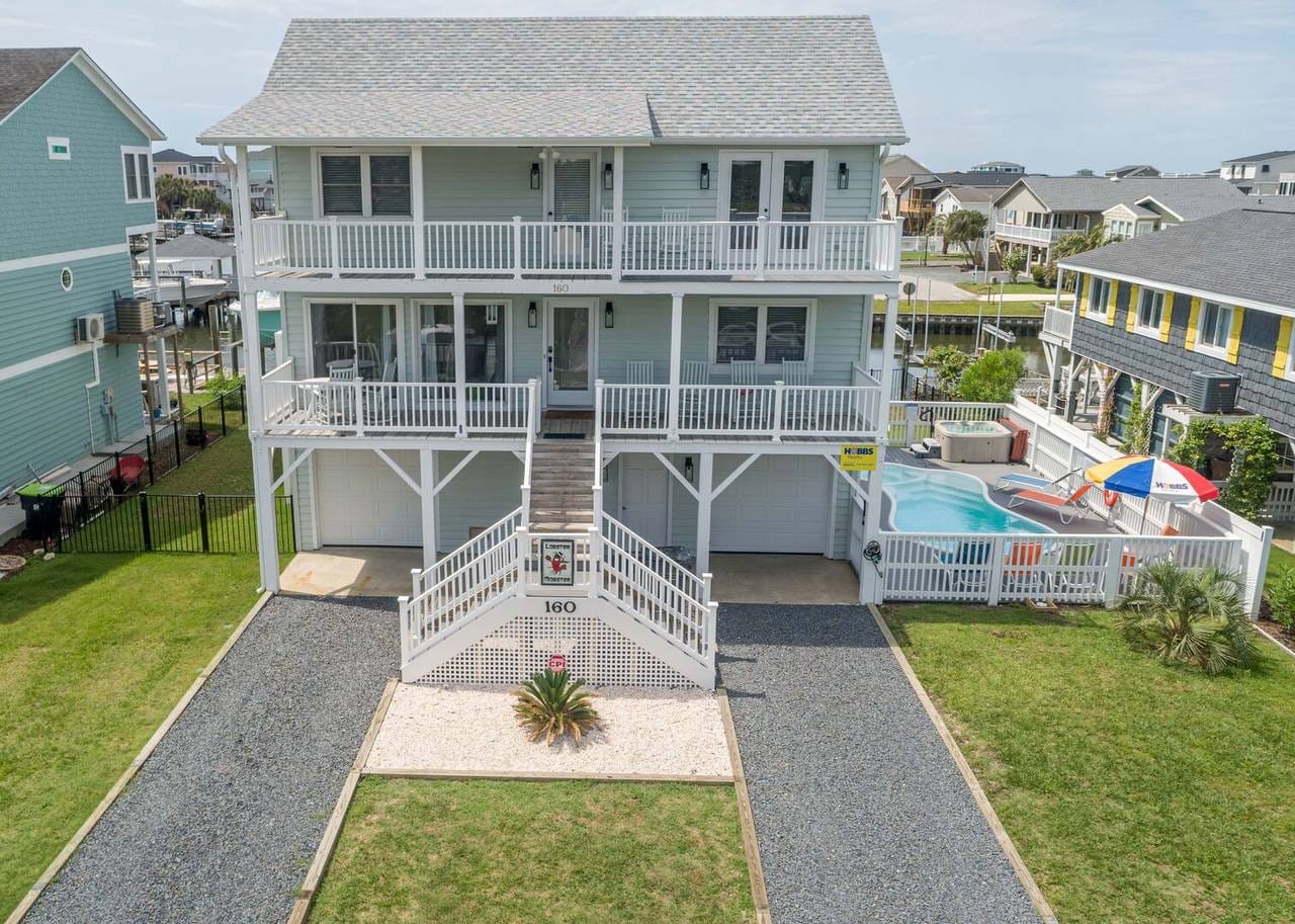 Two-story beach house with pool.