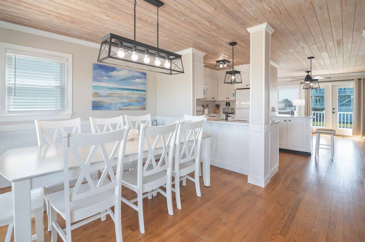 Bright kitchen-dining area with artwork.