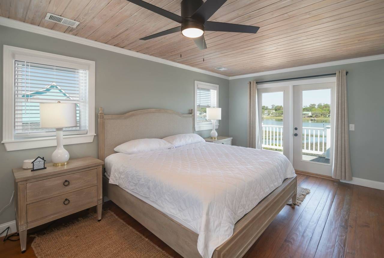 Bedroom with large bed, window view.