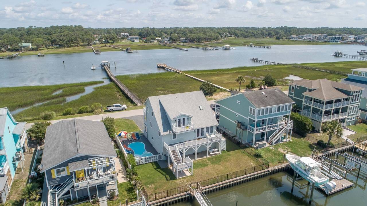 Waterfront homes with docks and boats.