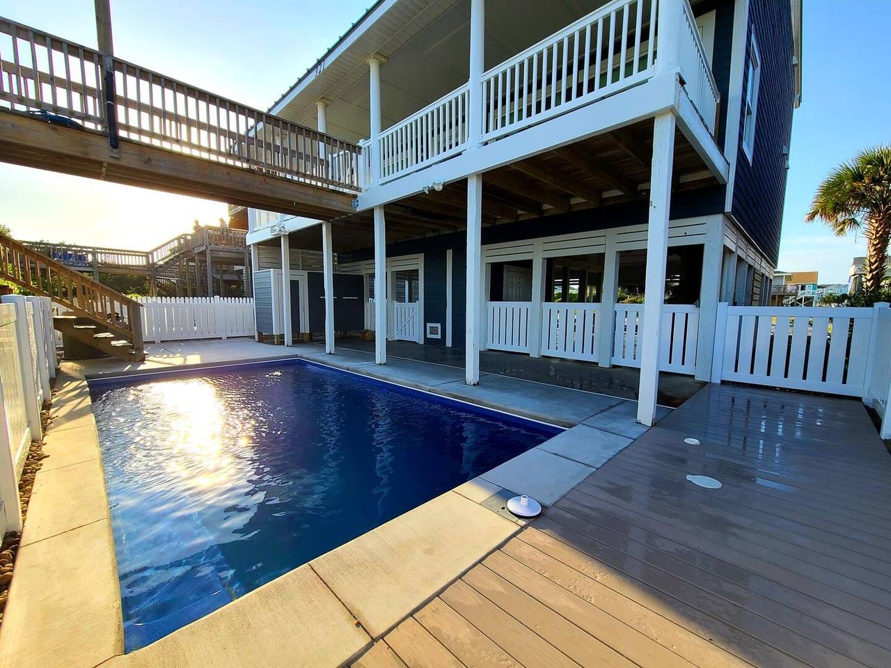 Backyard pool with surrounding deck.