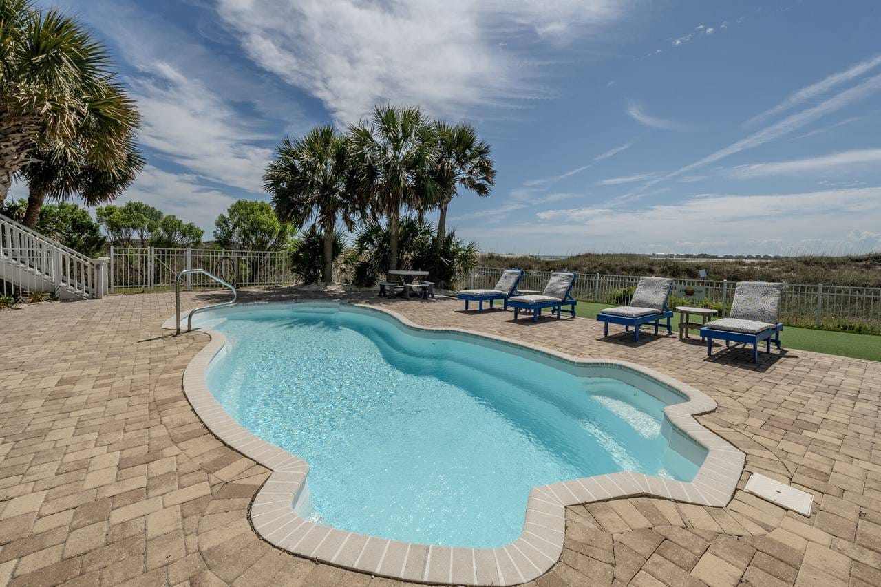 Poolside with loungers and palms.