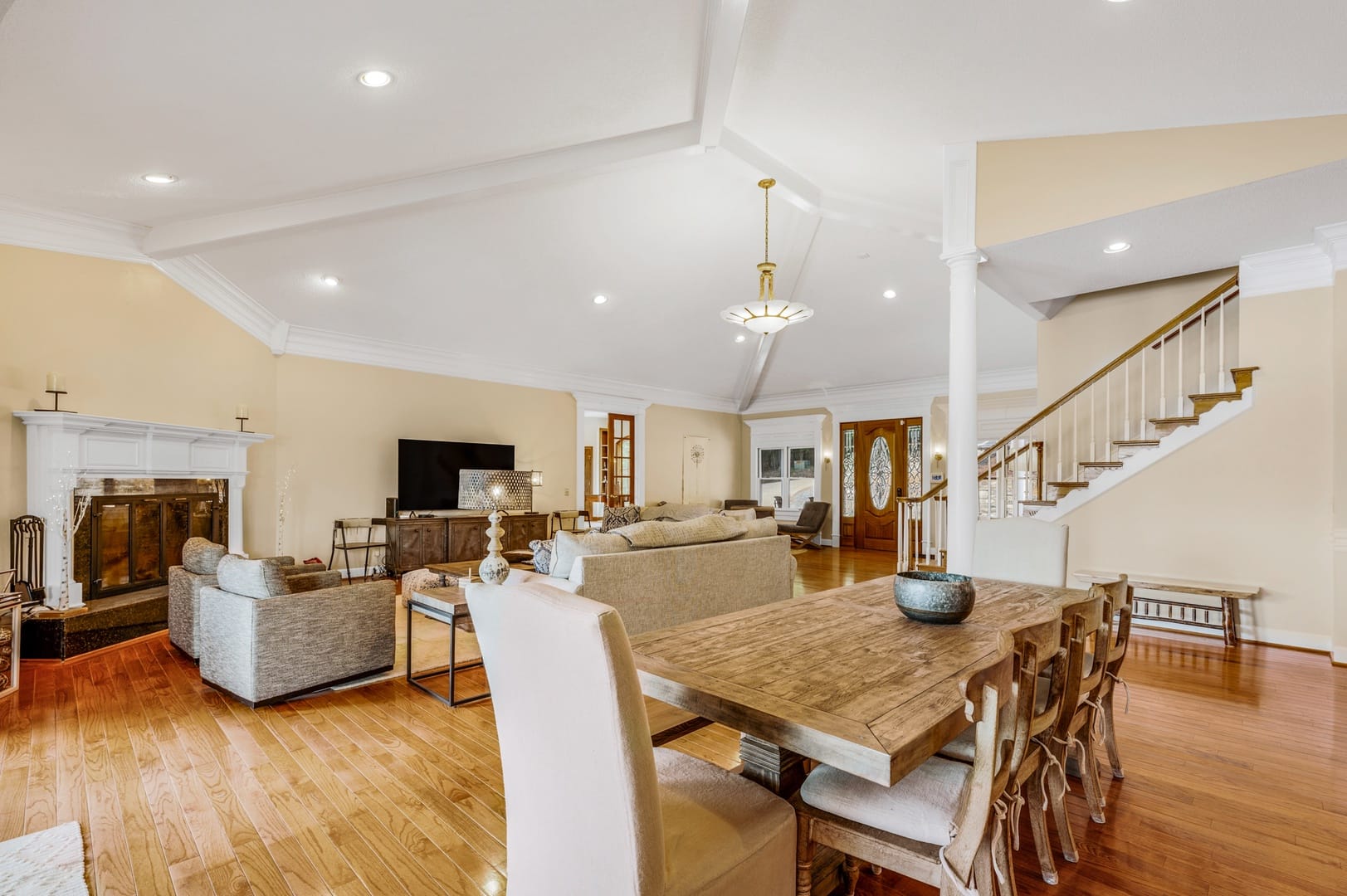 Spacious living room with staircase.