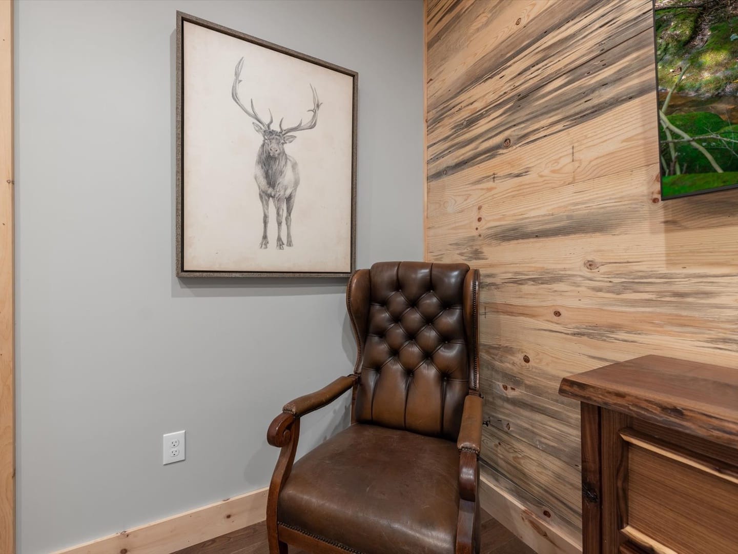 Chair beneath deer wall art.