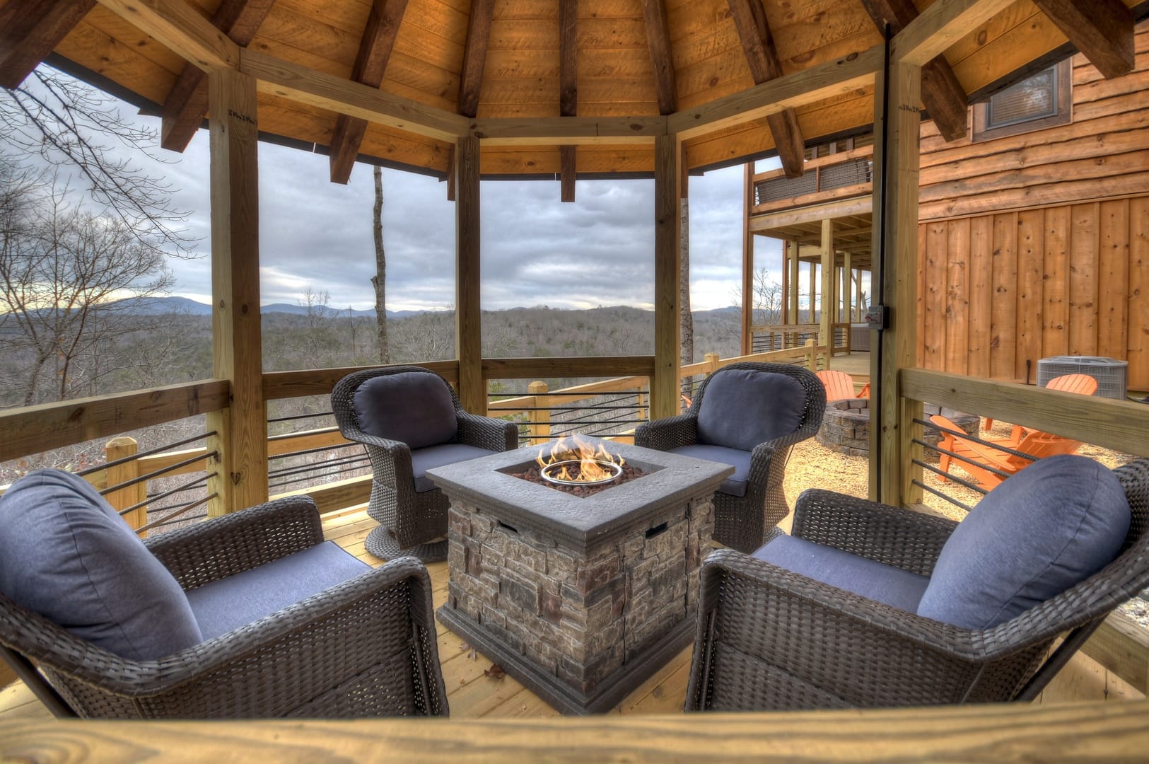 Gazebo with chairs and fire pit.