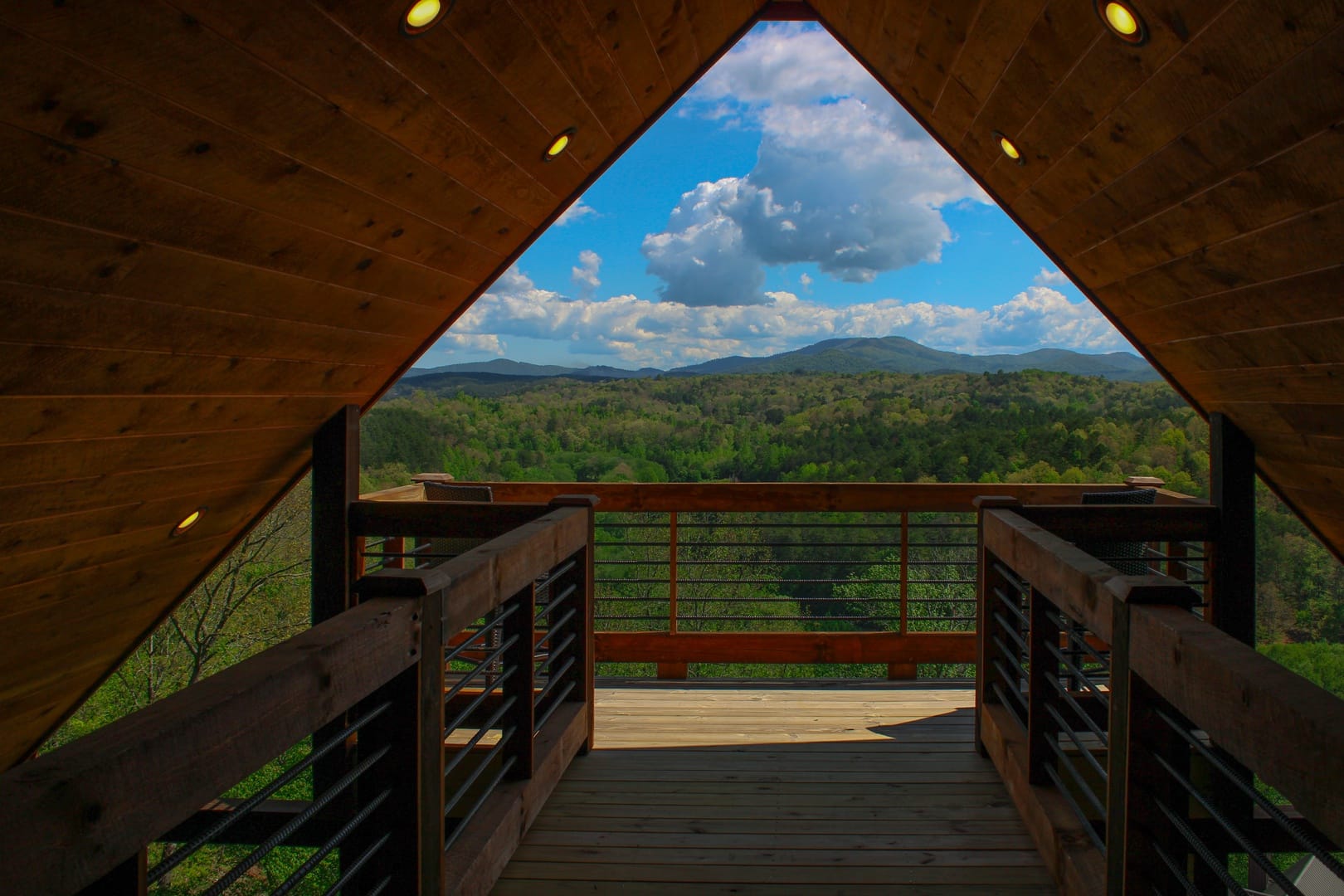 Wooden deck overlooking mountain view.