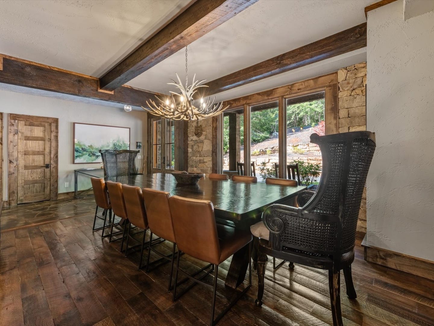 Rustic dining room with antler chandelier.