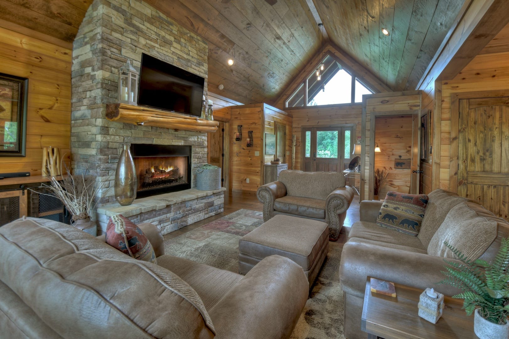 Rustic living room with stone fireplace.