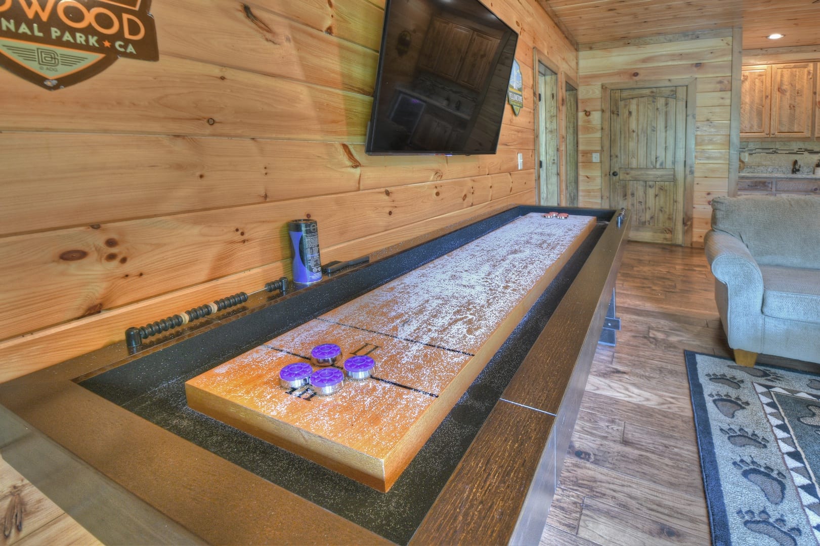 Shuffleboard table in wooden room.