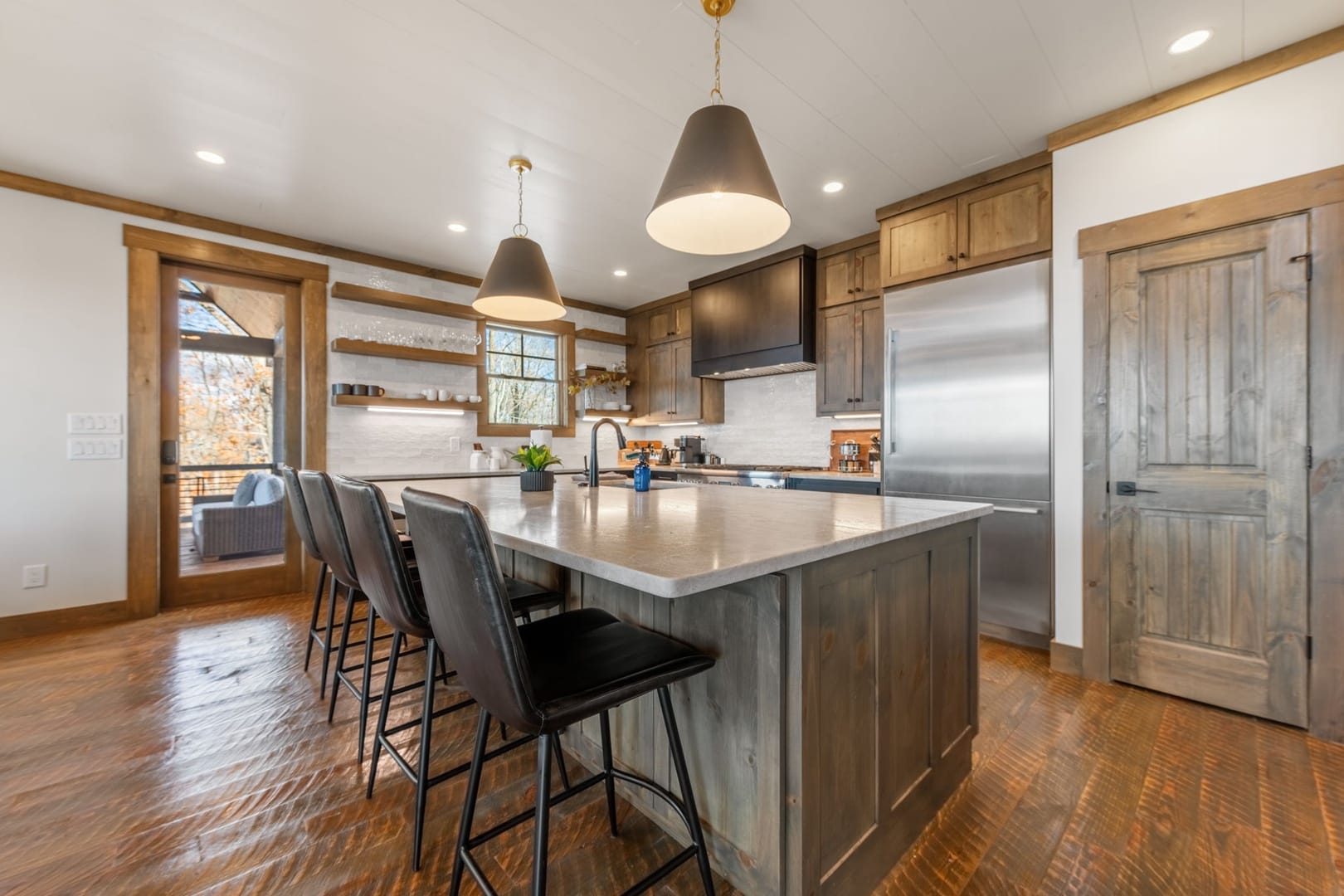 Modern kitchen with island and seating.