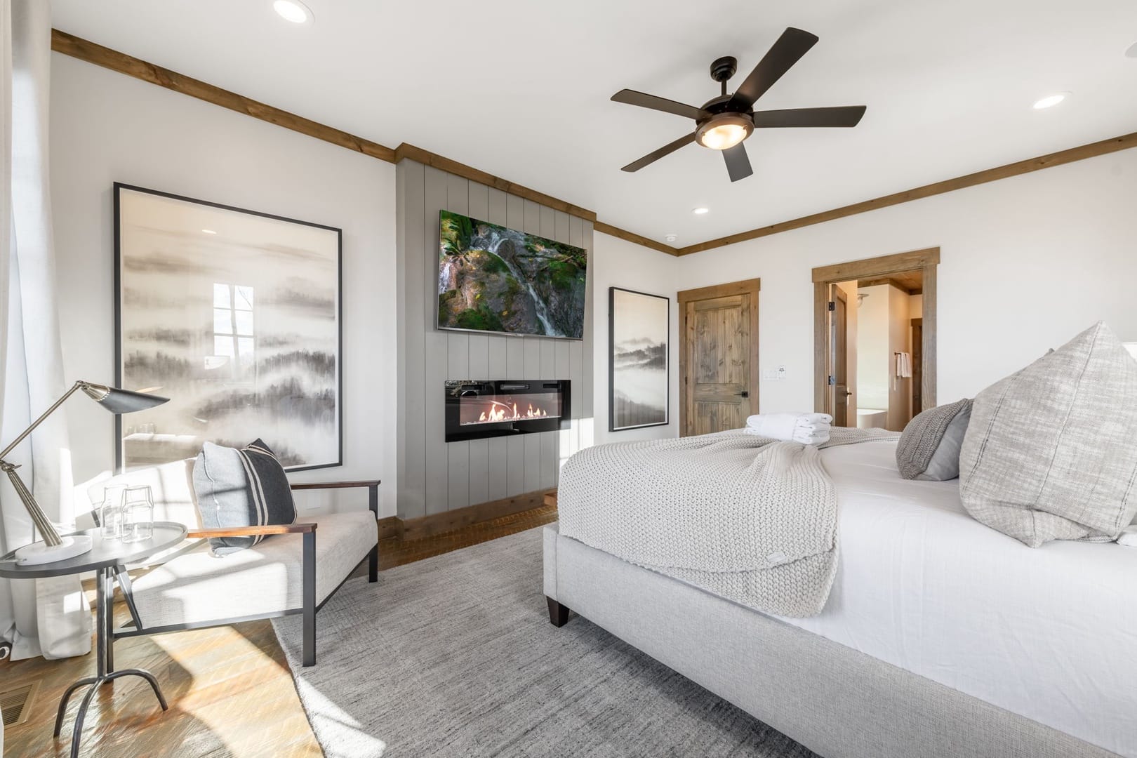 Cozy bedroom with fireplace, artwork.