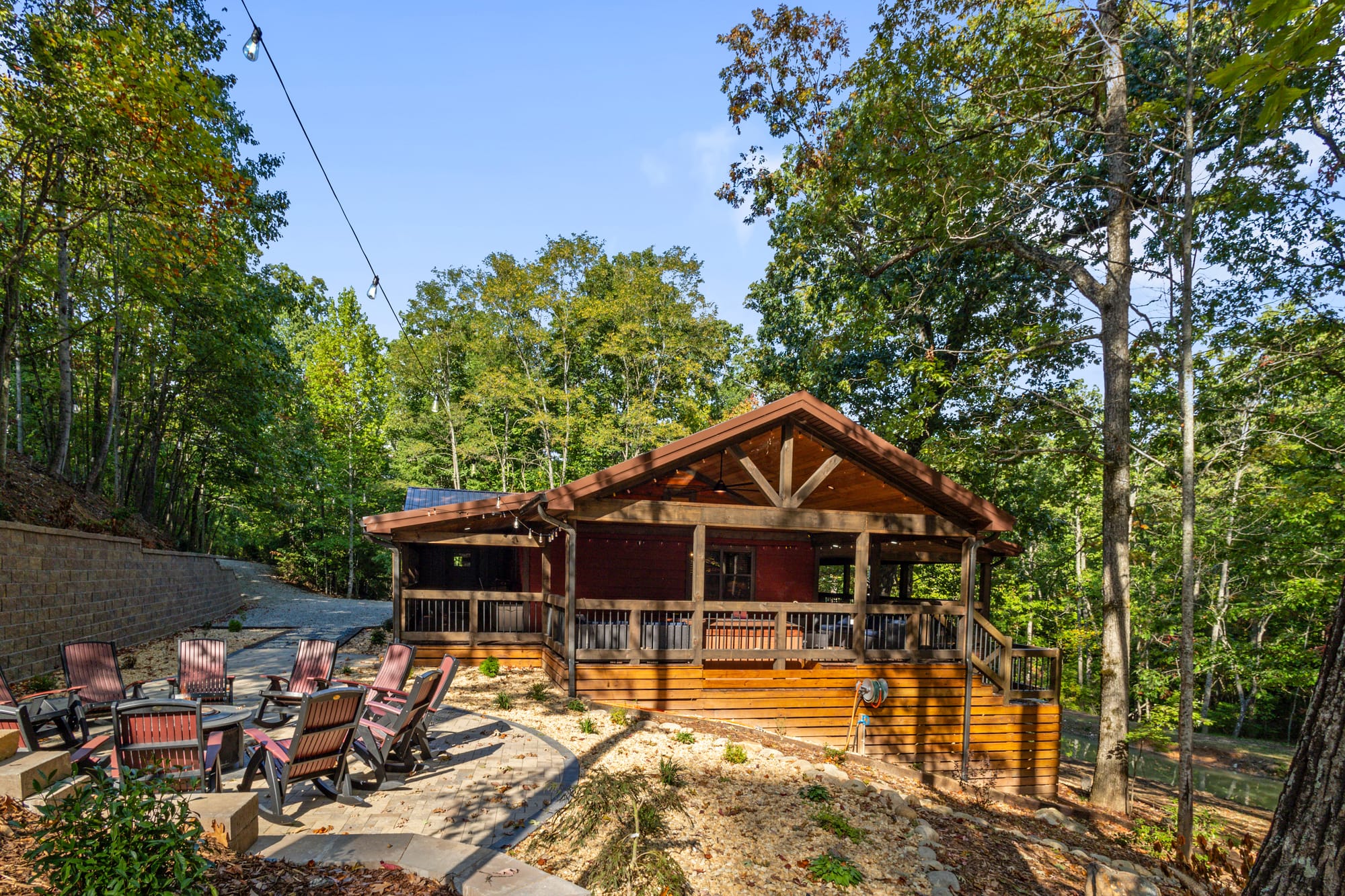 Wooden cabin with outdoor seating.