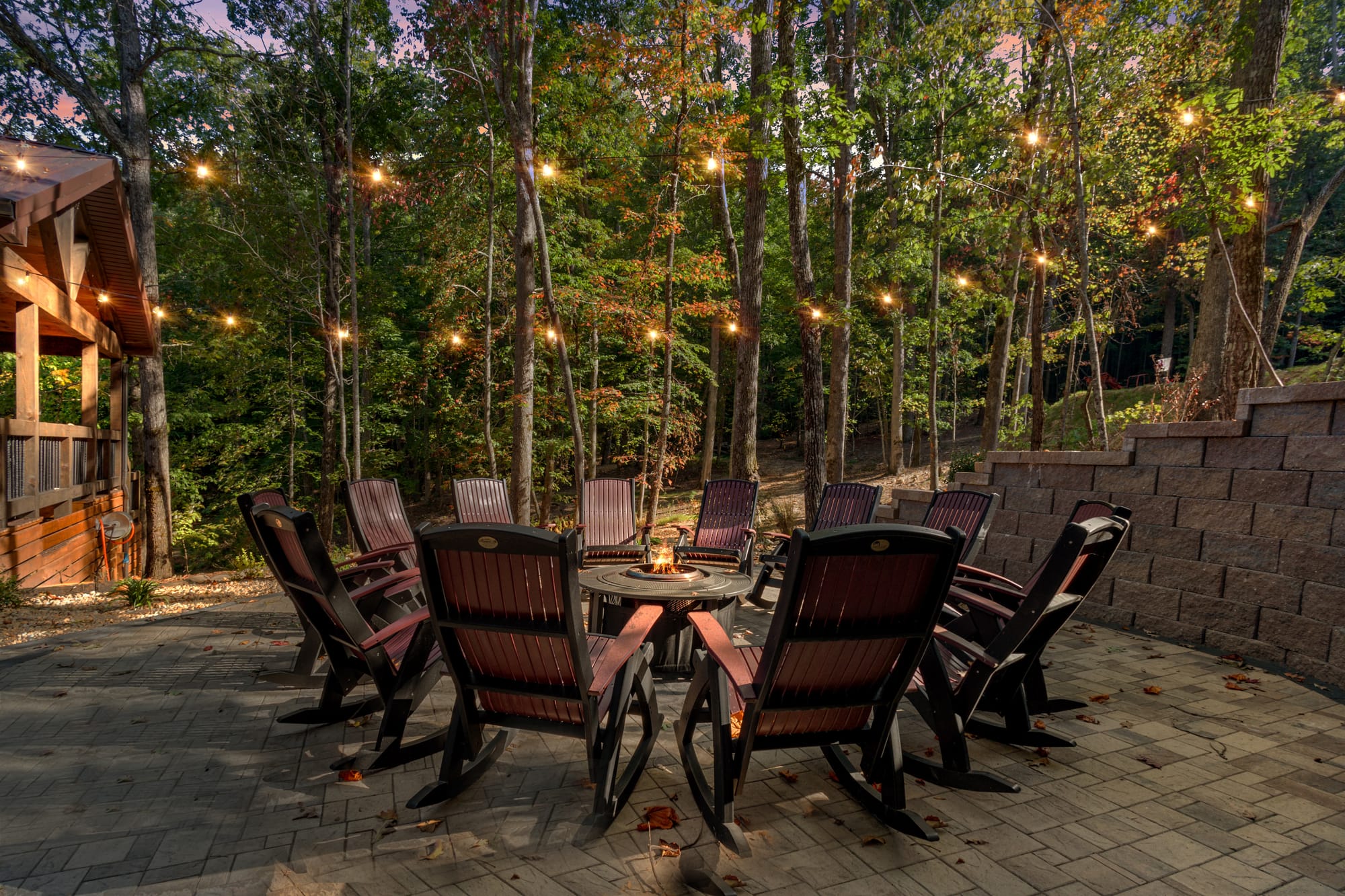 Outdoor patio with chairs and lights.