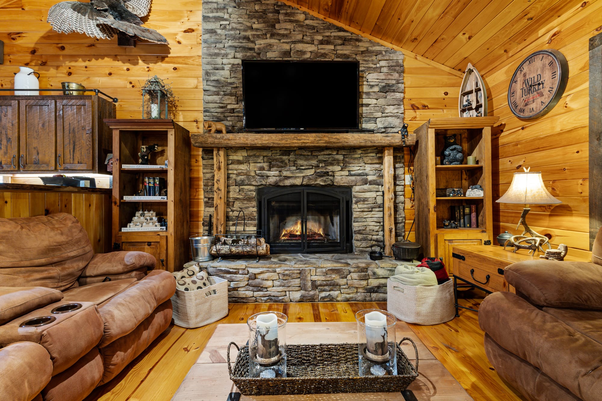 Rustic living room with stone fireplace.