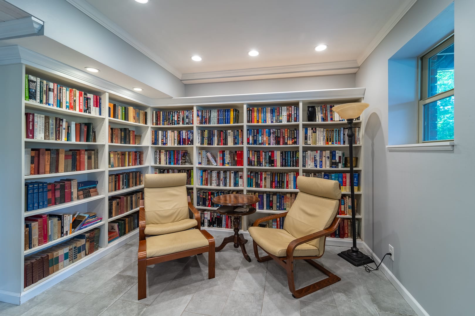 Cozy reading nook with bookshelves.