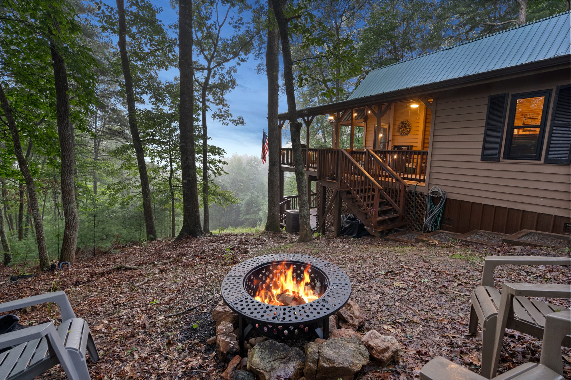 Cabin with fire pit, forest view.