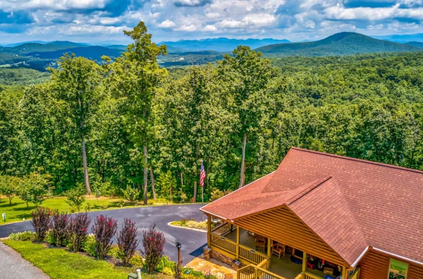 Cabin with forest and mountain view.