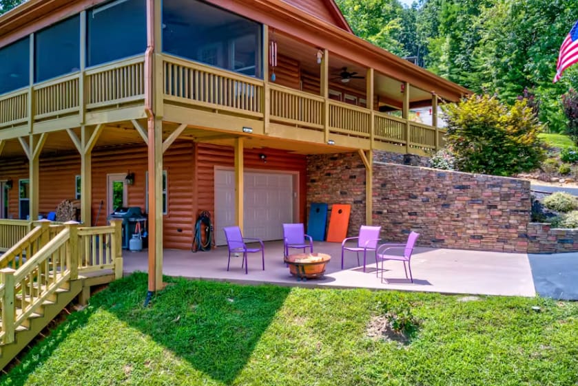 Cabin patio with purple chairs.