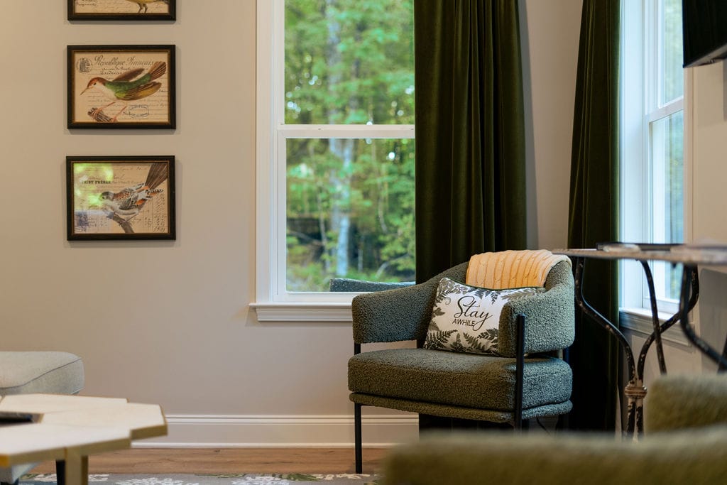 Cozy chair with decorative pillow.