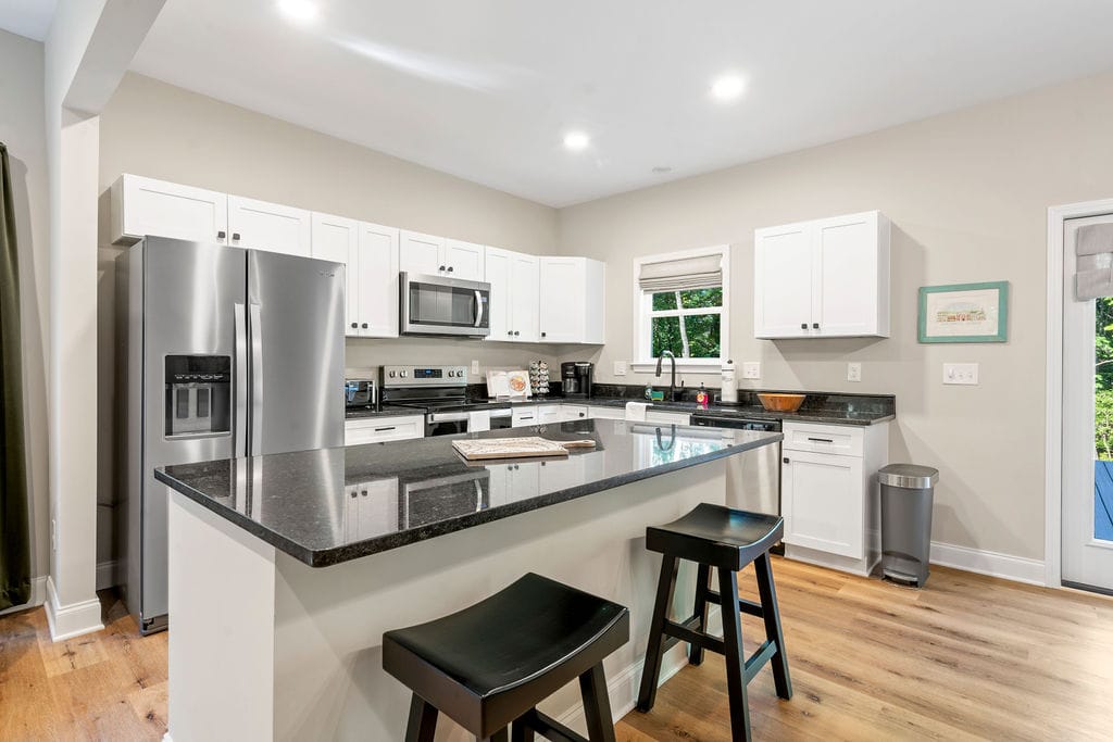 Modern kitchen with black countertops.