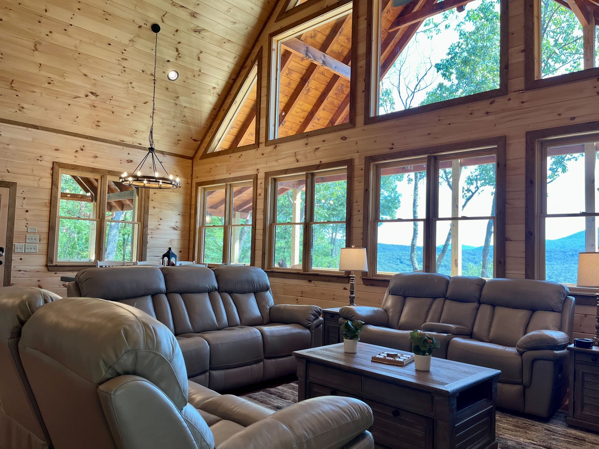 Cozy cabin living room, large windows.