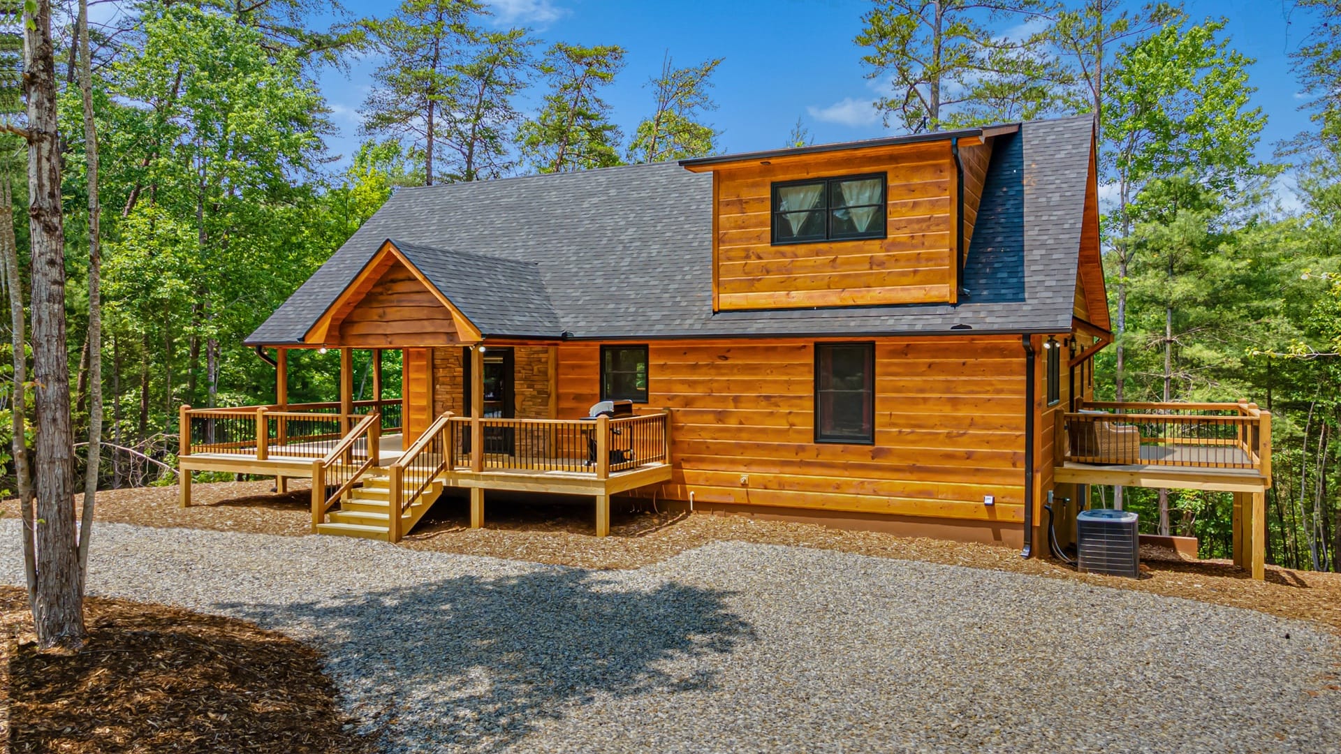 Log cabin with surrounding trees.