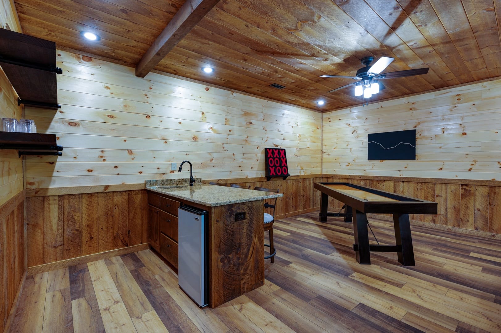 Rustic game room with kitchenette.