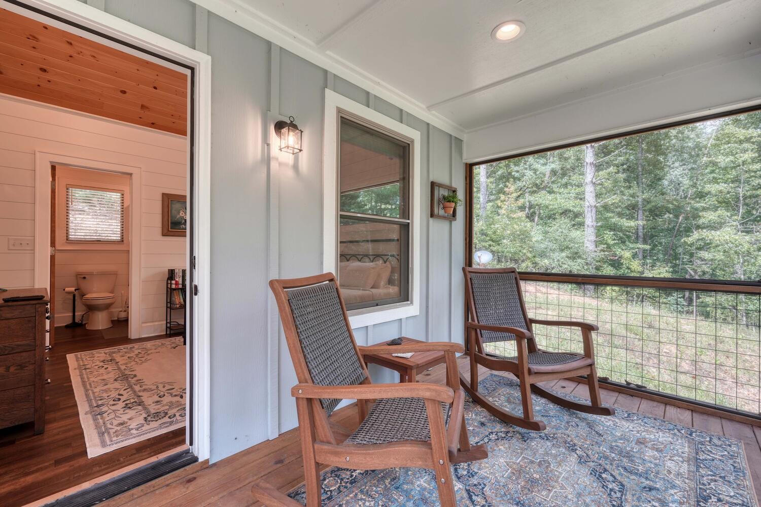 Porch with rocking chairs, bathroom visible.