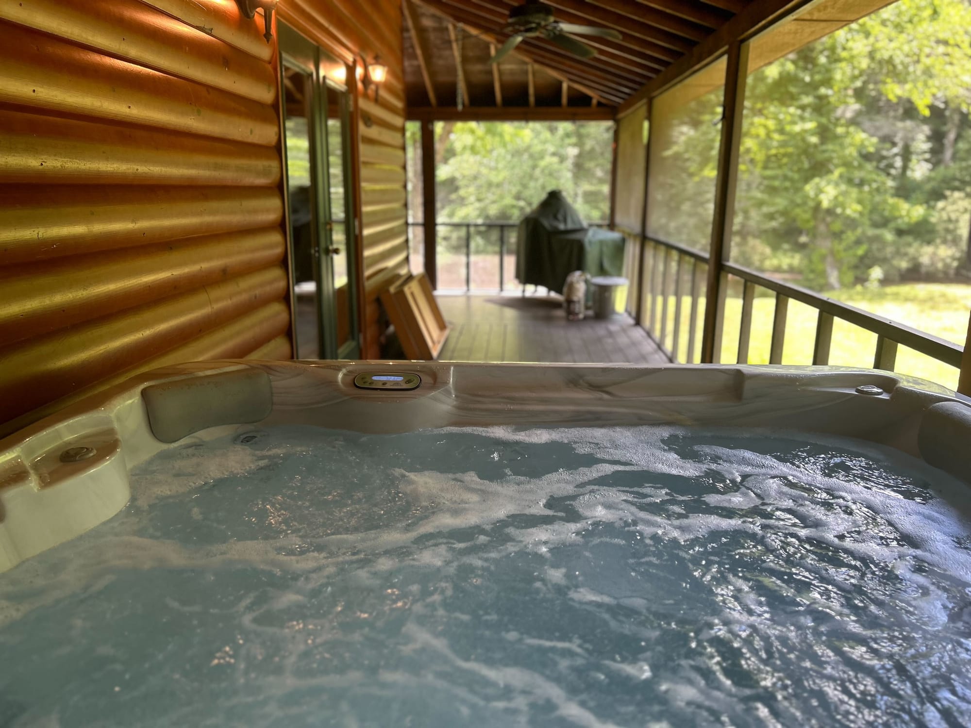 Hot tub on wooden porch.