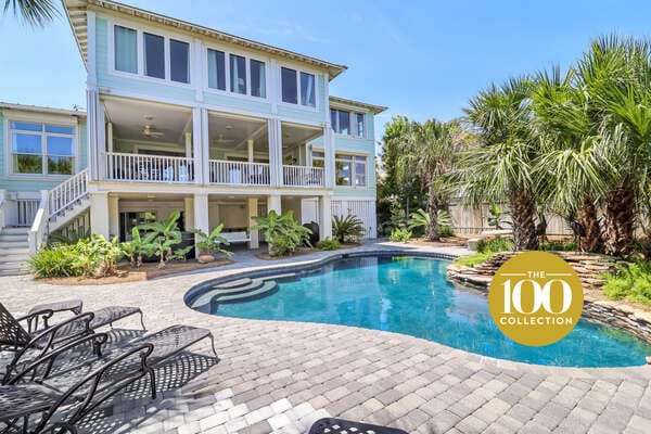 House with pool and palm trees.