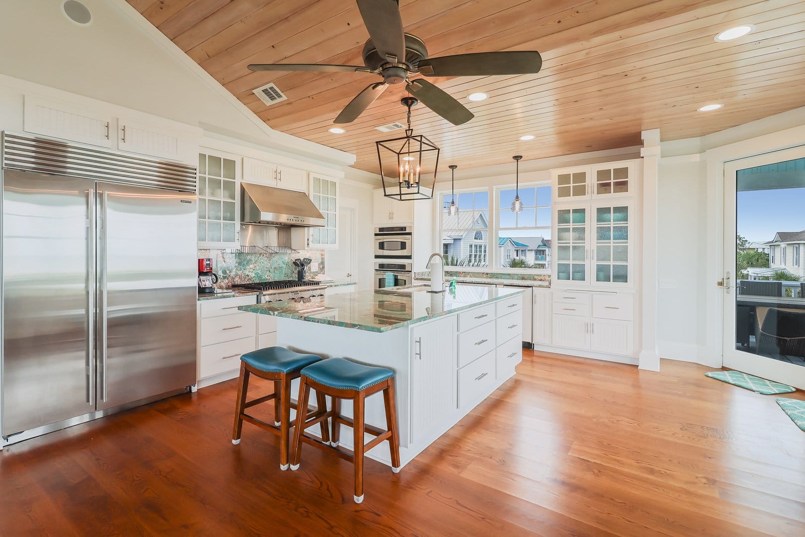 Spacious kitchen with wooden ceiling.